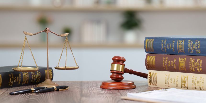 A professional legal setting showcasing law books, a gavel, and scales of justice, symbolizing the legal profession and justice.