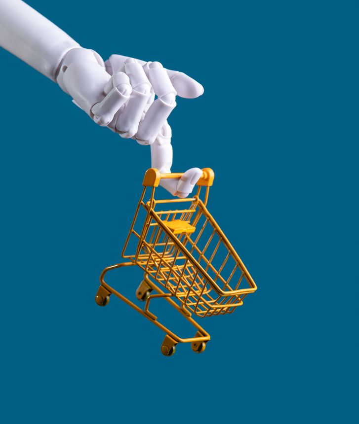 Robot Hand Holding a Miniature Shopping Cart: AI E-commerce, Automation, and Retail Concept