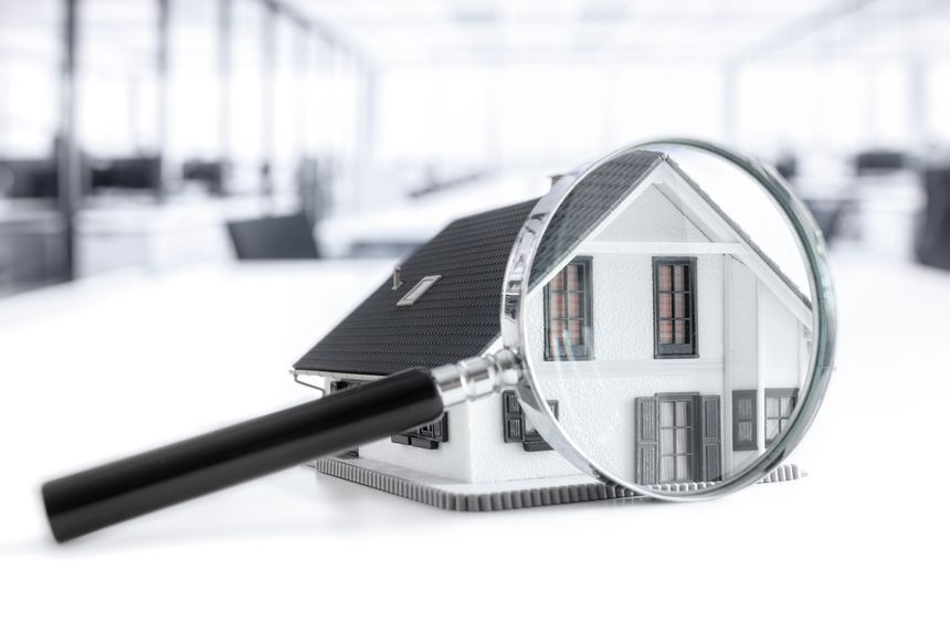 House with magnifying glass concept for home inspection or searching for a new house