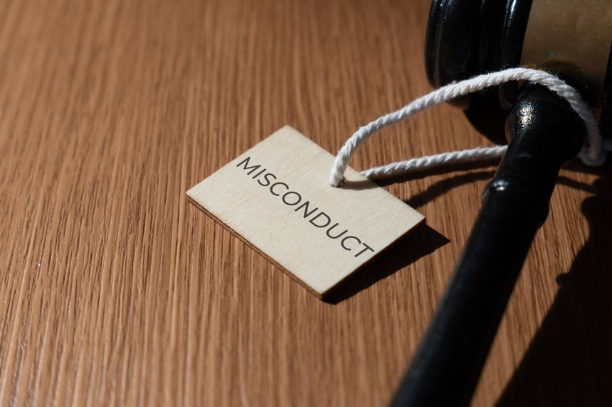 A gavel and a tag with the word MISCONDUCT. Legal and justice concept.