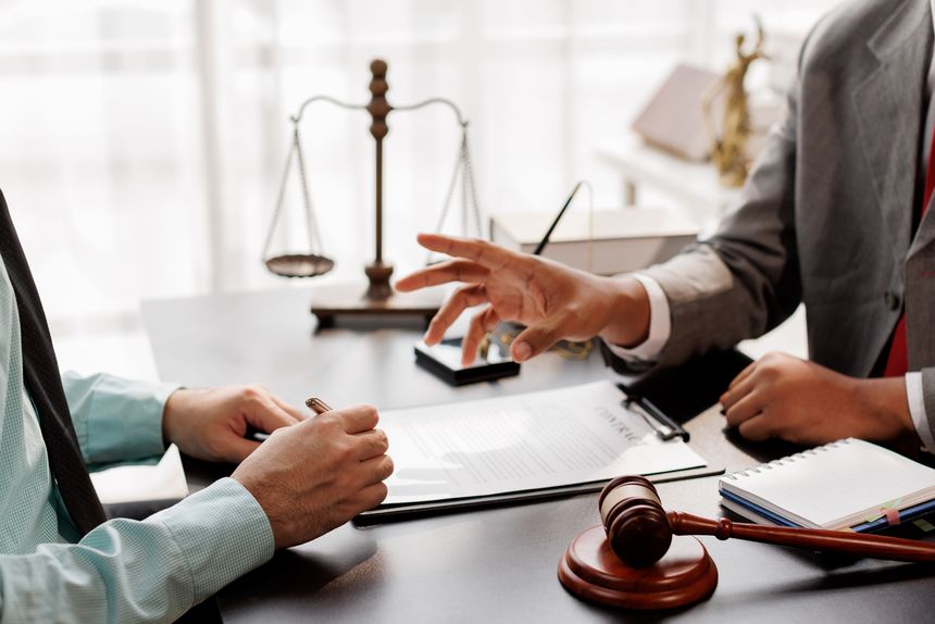 law and justice. Lawyer Legal counsel presents to the client a signed contract with gavel and legal law. justice and lawyer Business partnership meeting concept.