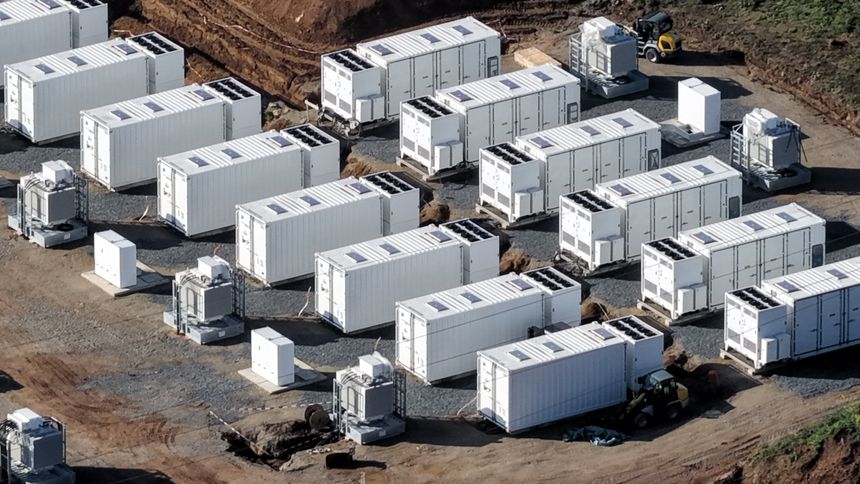 Aerial view of a large-scale battery storage construction site in Germany, highlighting the expansion of energy storage infrastructure as part of the renewable energy transition. Battery storage systems are essential for managing fluctuations in renewable energy generation, particularly from wind and solar sources. They enable efficient storage of excess electricity and provide rapid energy supply during peak demand, contributing significantly to grid stability and reliability. The construction phase demonstrates the rapid growth of energy infrastructure required to meet climate goals and support decarbonization strategies. Such projects are key elements in modern smart grids and play a vital role in ensuring energy security, reducing dependence on fossil fuels and enabling a sustainable future. The footage is suitable for topics related to clean energy, infrastructure development, energy storage technology, electricity systems and environmental sustainability.