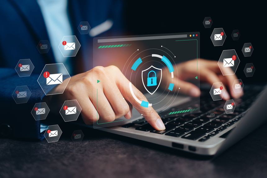 Email cybersecurity concept. Businessman typing on laptop with virtual lock shield and warning icons representing spam protection, data encryption, and secure communication