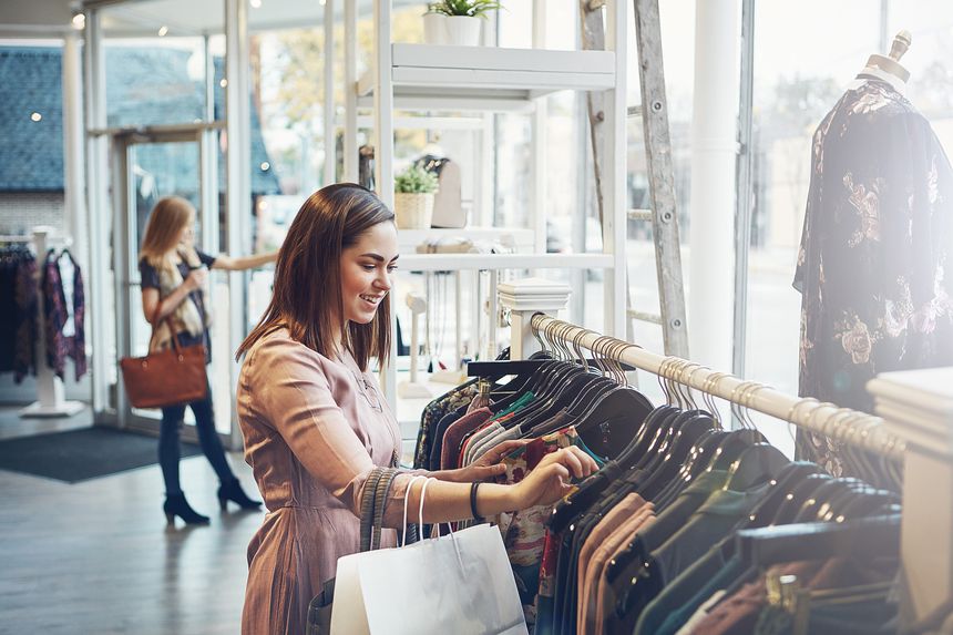 Shot of a young woman shopping at a clothing store