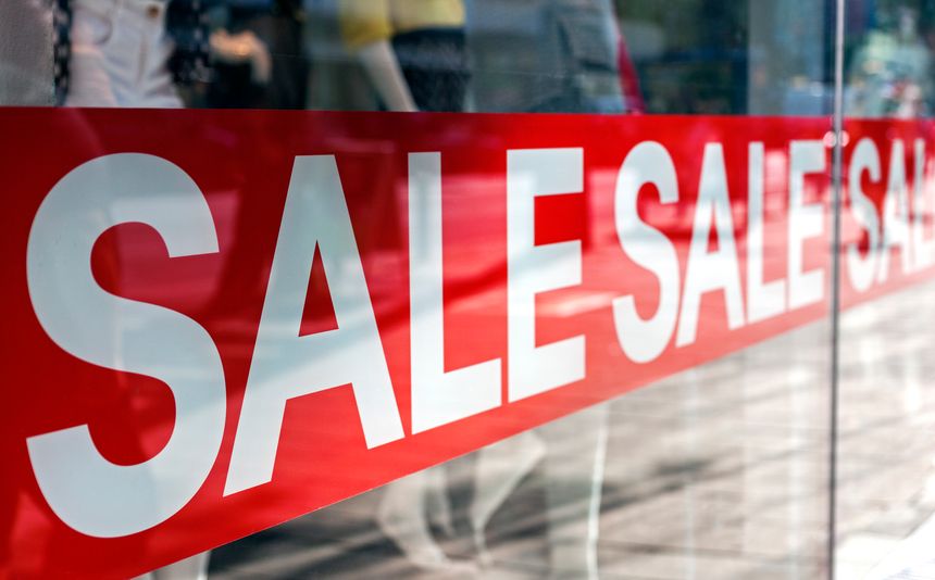 Picture of shop window display with text Sale on red poster