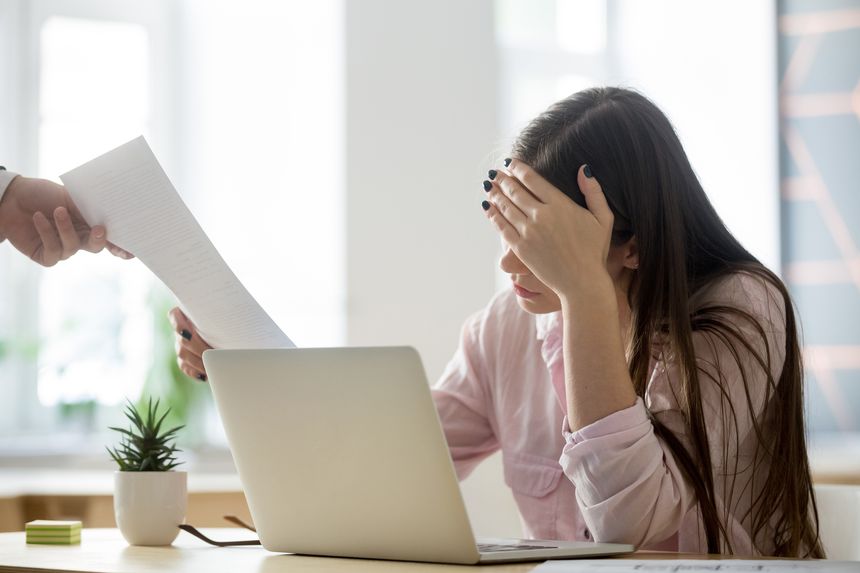Frustrated female employee feeling upset receiving dismissal notice from boss getting fired losing job, depressed bankrupt businesswoman distraught by paper notification about debt, student expelled