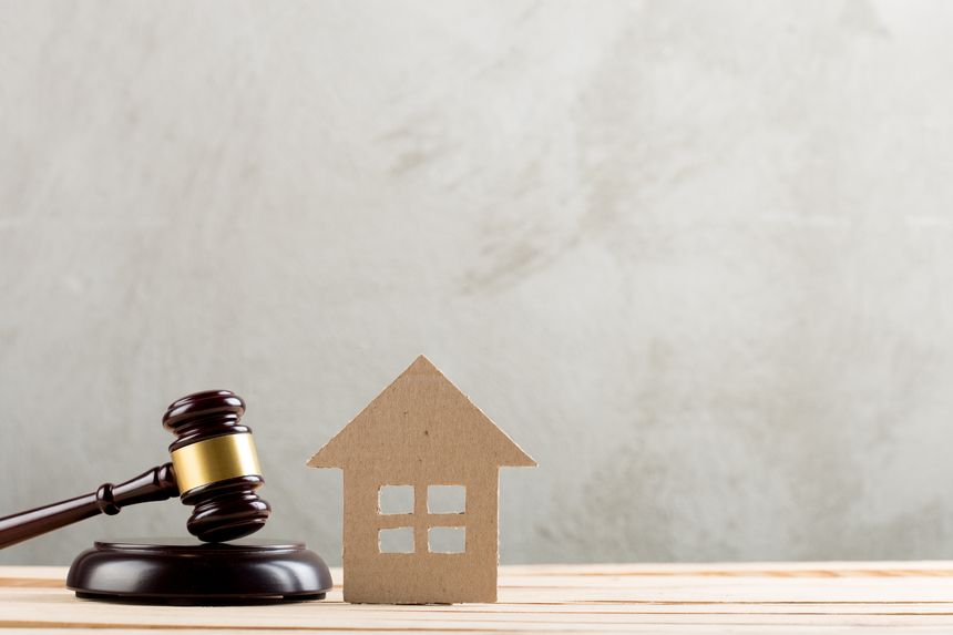 Real estate sale auction concept - gavel and house model