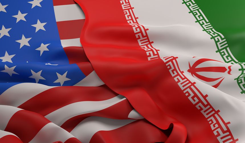 Flag of Iran laying over the US flag