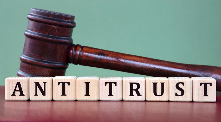 ANTITRUST - word on wooden cubes on background of judge's gavel. Info concept
