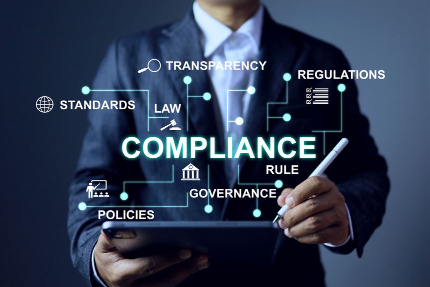 compliance concept with a businessman using tablet to check and submit document for regulation requirement to comply a standards