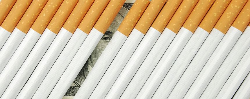 the cigarettes laying on american money