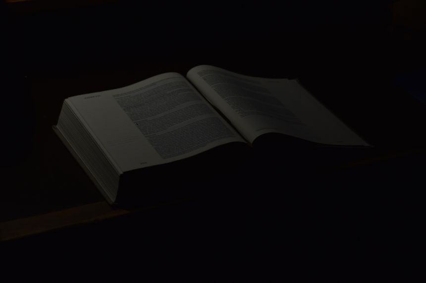 there is a book that is open on a table