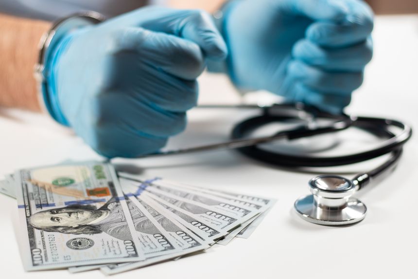 Doctor with handcuffs and money. Medical crime.
