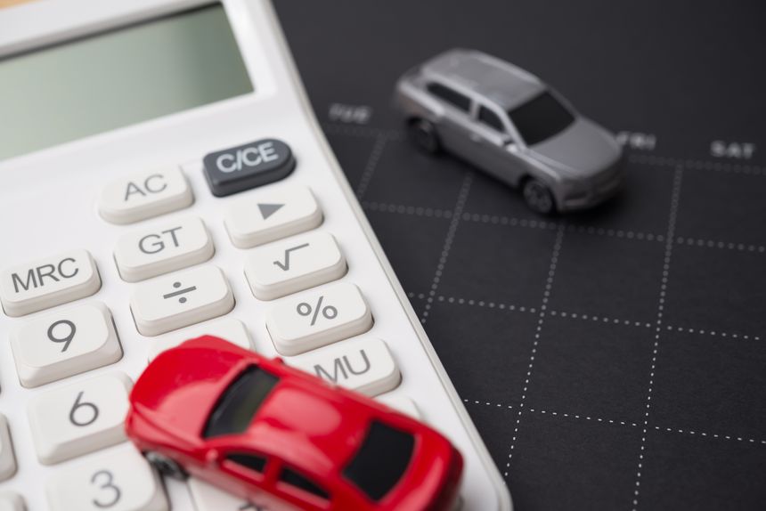 Toy cars model, black calendar and white calculator. Money financial management and calculation for buying car, car leasing, down payment, installment, auto insurance, service costs and so on concept.