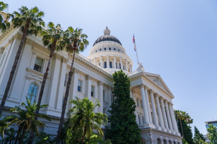 Sacramento, California, USA - June 21st 2025: California Historic Capitol building, side view, with Californian and US flags