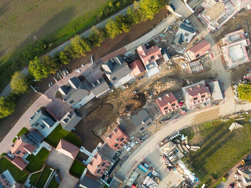 Drone top down view of two rows of new homes on a British housing estate. Features both first time and family buyers which is commuter distance to London.