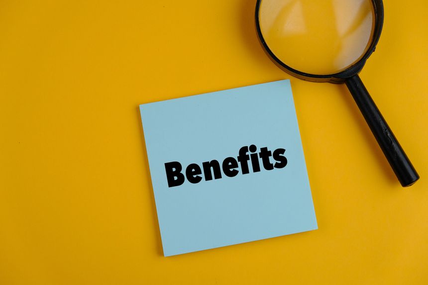 text of BENEFITS on the plain blue paper on yellow background. business concept.