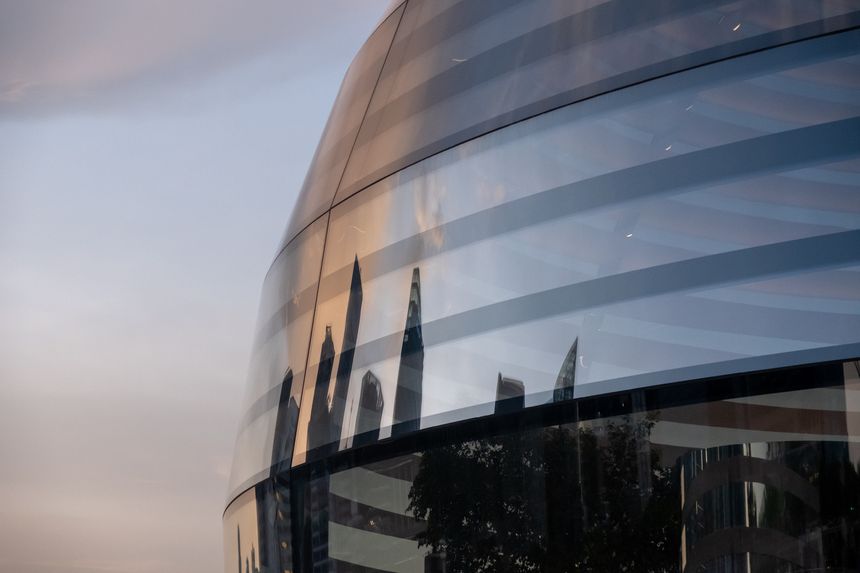 Singapore - 20 October 2022: Apple Marina Bay Sands facade with a reflection of cityscape. The World's First Floating Apple Store, designed by Foster + Partners