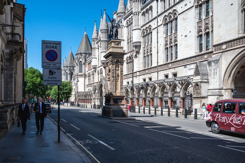 London, UK 10 July 2025 The Strand with The Royal Courts of Justice (Law Courts) building in London and Temple Bar Memorial with dragon symbol of London