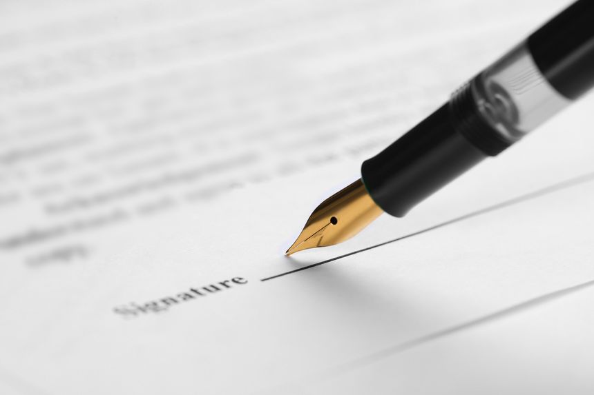 Signing notary document with fountain pen, closeup. Space for text