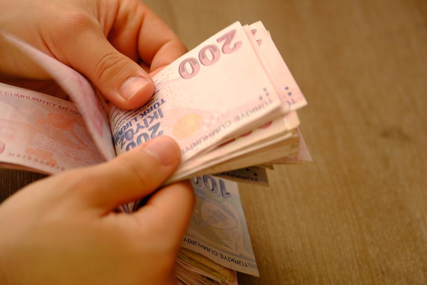 Turkish lira, currencies and economy. 200 Turkish lira banknotes. Close-up of male hands counting money. Inflation. Salary increases, pensions. Year-end raise. Economic crisis, economic development. Bundles of money. Stock market index. Financial sector. Business world.