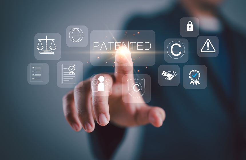 Patented patent copyright law business technology concept. businessman touch virtual screen of patented word with copyright icons for author rights and patented intellectual property.