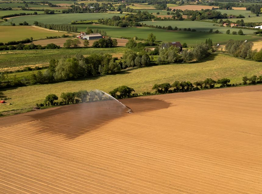 An aerial view of farmland being irrigated near Bures in Suffolk, UK