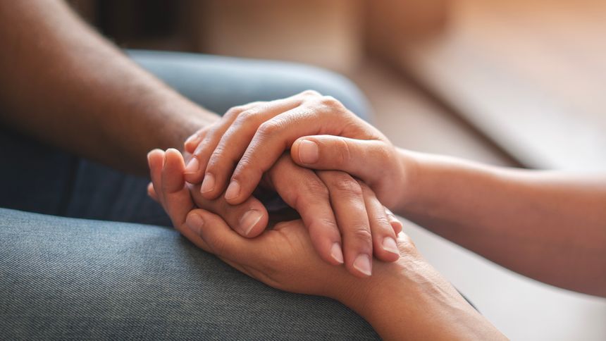 Closeup shot of two unrecognizable people holding hands in comfort