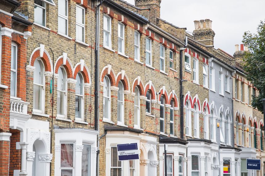 Estate agent signs displayed outside terraced houses in Harringay Ladder area, London, England