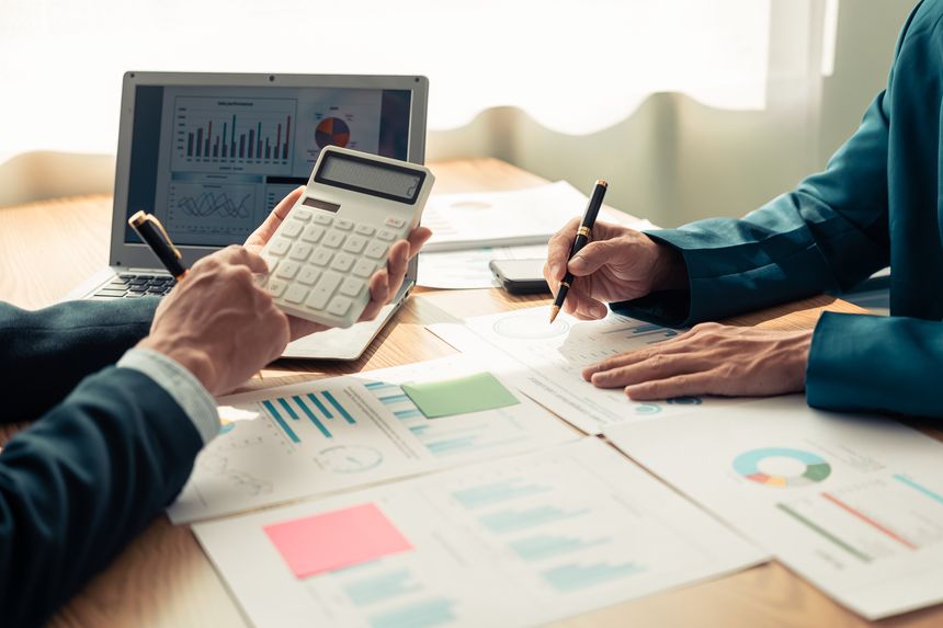 Close up of hands of business team during discussion. Financial charts and graphs on the table. Successful teamwork. Business meeting.