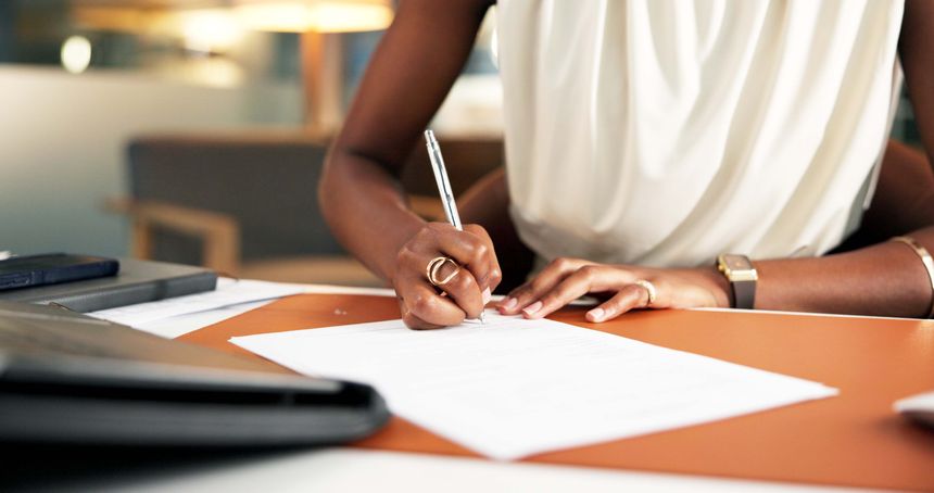 Signature, documents and hands of business woman in office for legal agreement, drafting policy and writing. Lawyer settlement with terms and conditions for employee in agency for paperwork guideline