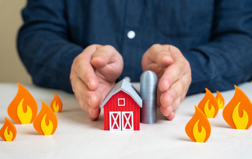 A man protects a farm from fire. Safety in difficult climate conditions. Droughts and fires. Saving agricultural crops. Emergency preparedness, crop insurance. Environmental challenges