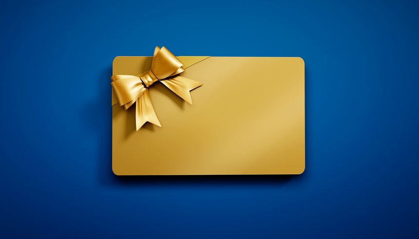 Golden credit or gift card with golden ribbon isolated on blue background - 3D illustration