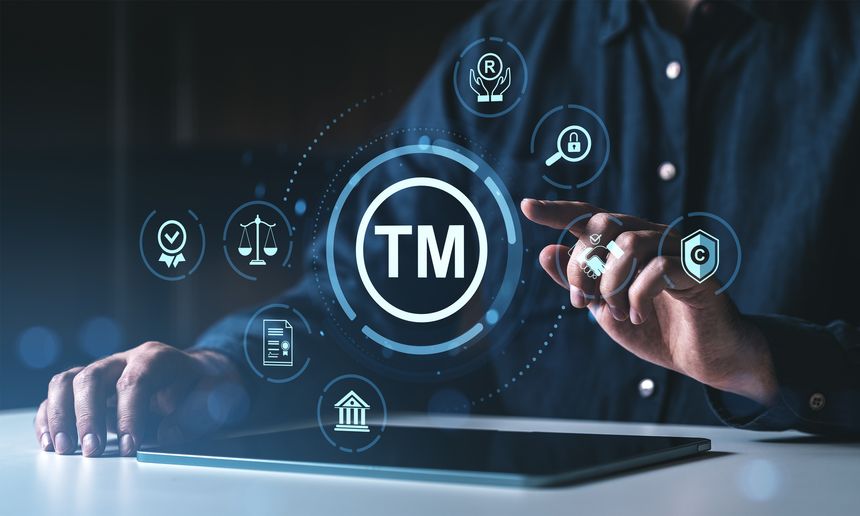 Man interacting with trademark protection icons on a digital interface, futuristic style, dark background, concept of legal intellectual property