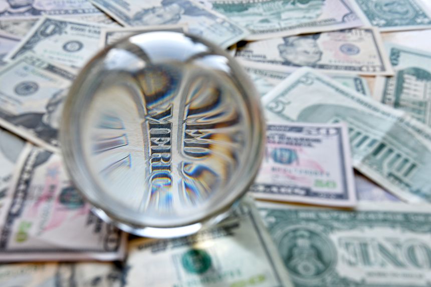 US dollar bill seen through a crystal ball. Creative concept, business, banking, taxes and finance