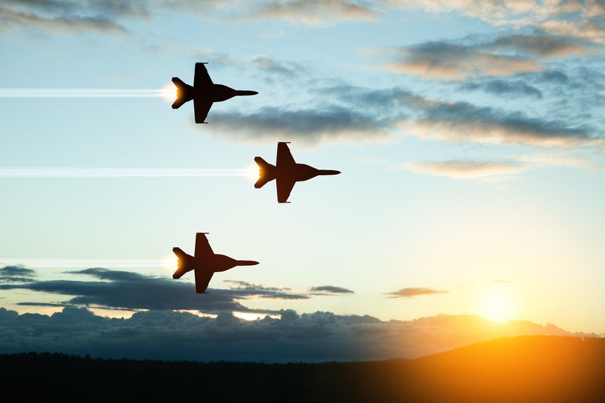 Air Force Day. Aircraft silhouettes on background of sunset. Combat flight of interceptors on a mission.
