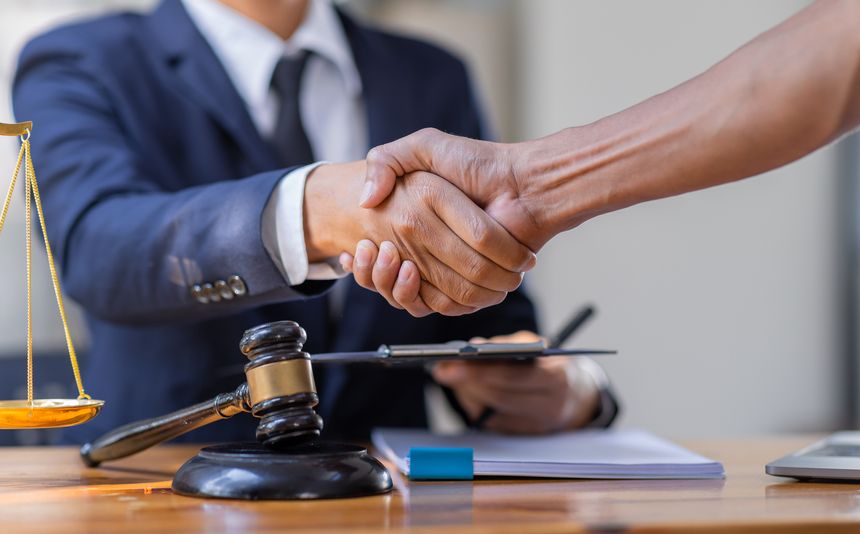 Lawyer who provides legal advice in the office. Businessman and lawyer shaking hands.