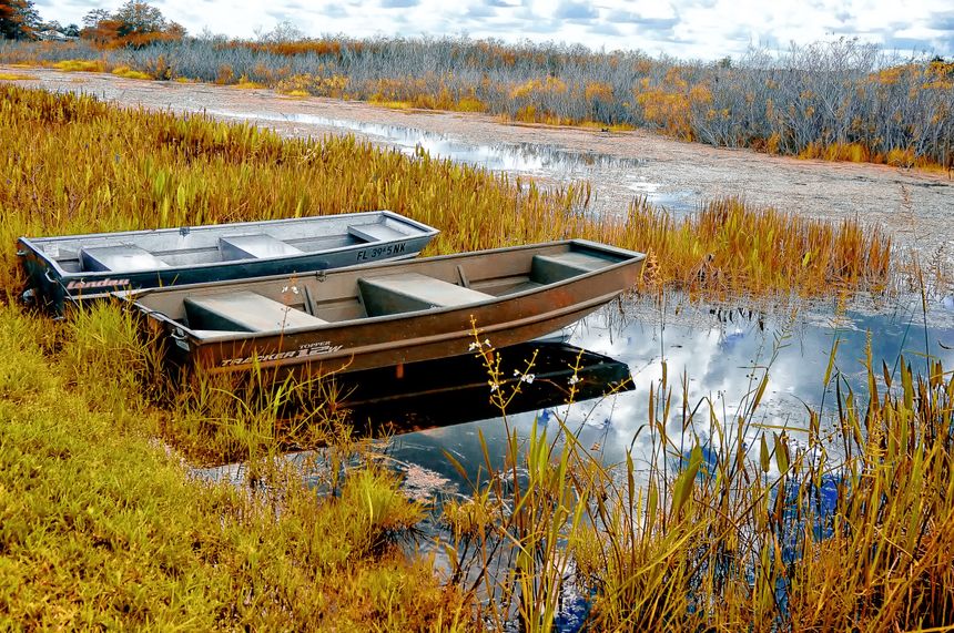 tin boats on the shore of the autumn marsh