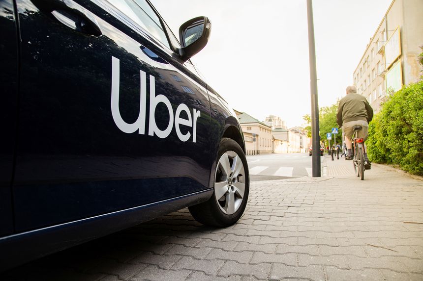 Warsaw, Poland - April 30, 2019: View on Uber car (Skoda) with inscription on the street before sunset