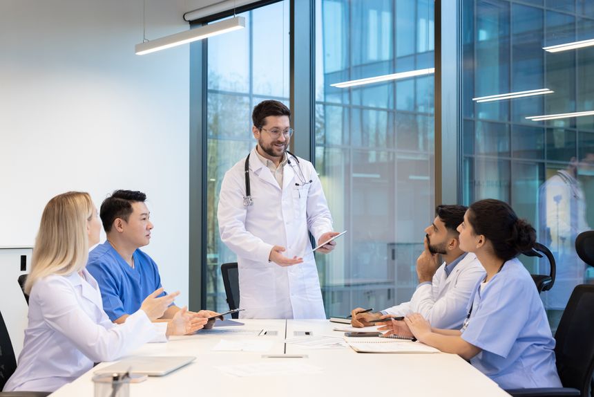 Healthcare professionals gather in a modern workspace to discuss medical cases, strategies, and treatments. Collaborative teamwork is emphasized, showcasing the importance of communication