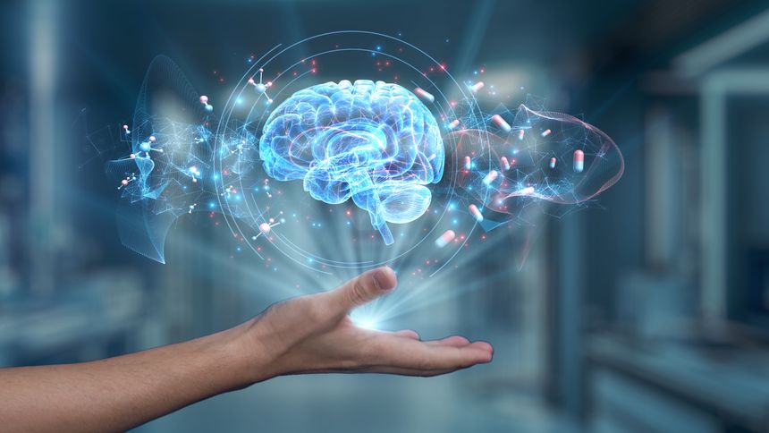 Close up of human hand holding brain holographic floating at laboratory background. Human hand accessing and connecting medical data by using brain icon to analyzing and diagnosis symptom. Salubrious.
