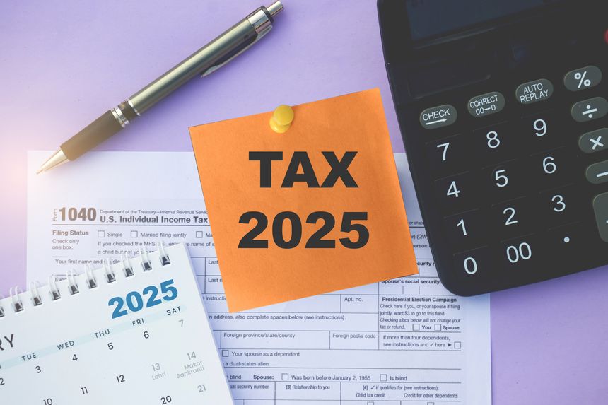 USA individual Income tax return form with sticky notes Tax 2025, Financial Year 2025 Calendar, Calculator attached with Pushpin.