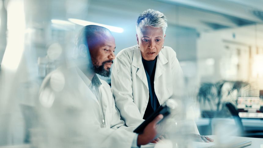 Discussion, scientists and team with tablet, lab or collaboration for medical research for analysis. Healthcare, science and mature people with tech for biotechnology, breakthrough and communication