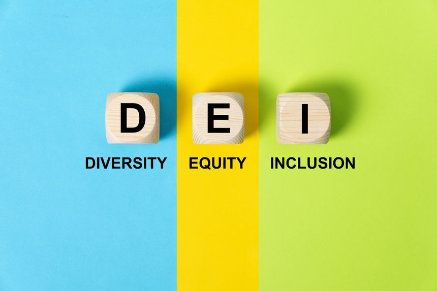 DEI words on wooden cubes on colorful background, which means diversity, equity and inclusion.