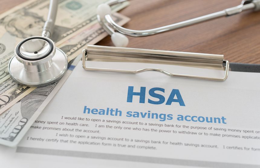 health savings account, HSA concept with application form,dollar money, stethoscope on desk.