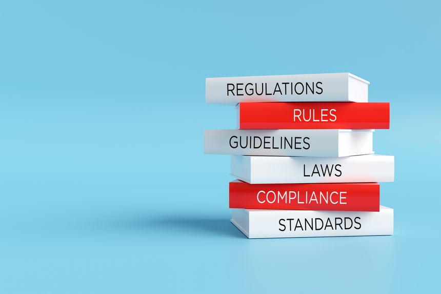 Books forming a stack with words regulations, rules, guidelines, laws, compliance and standards, compliance concept. 3D render.