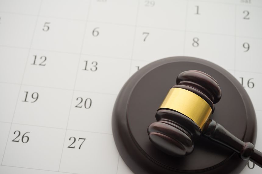 Judge wood gavel hammer on white blank calendar background copy space. Law, judgement, agenda schedule or appointment for legal process concept.