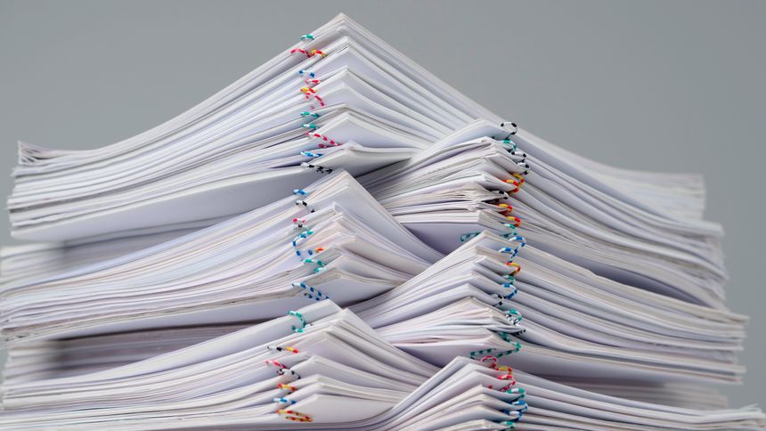 Workplace paperwork routine creative advertisement concept. Time lapse of paper sheets on white background. Stop motion animation of big tower with many business paper documents with clips.