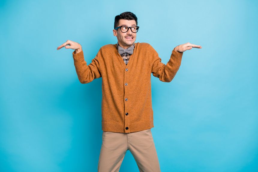 Photo of young funky happy man hands wings look empty space wear sweater pants bow tie isolated on blue color background