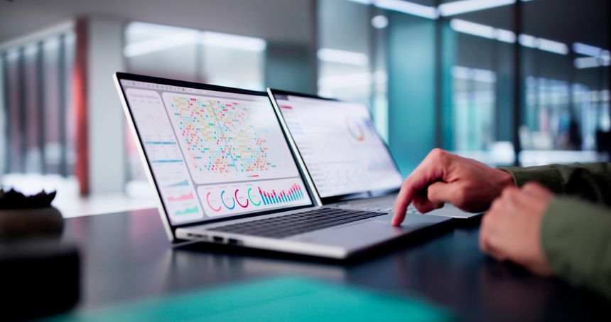 Male Data Analyst Predicting Market Trends On Virtual KPI Dashboard In Emerging Financial Business Concept.